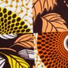 couverture plaid bébé patchwork wax cercles et fleurs jaune orangé et double gaze couleur papaye à pois doré. Doublure en minky à pois